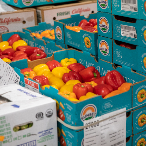 A picture of stacked boxes of yellow and red peppers.