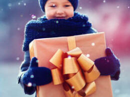 Small child with a big gift in their hands.