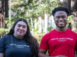 Two students wearing John R Lewis college t-shirts.