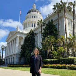 Picture of Prof. Rebecca London in front of the Sacramento capitol building.