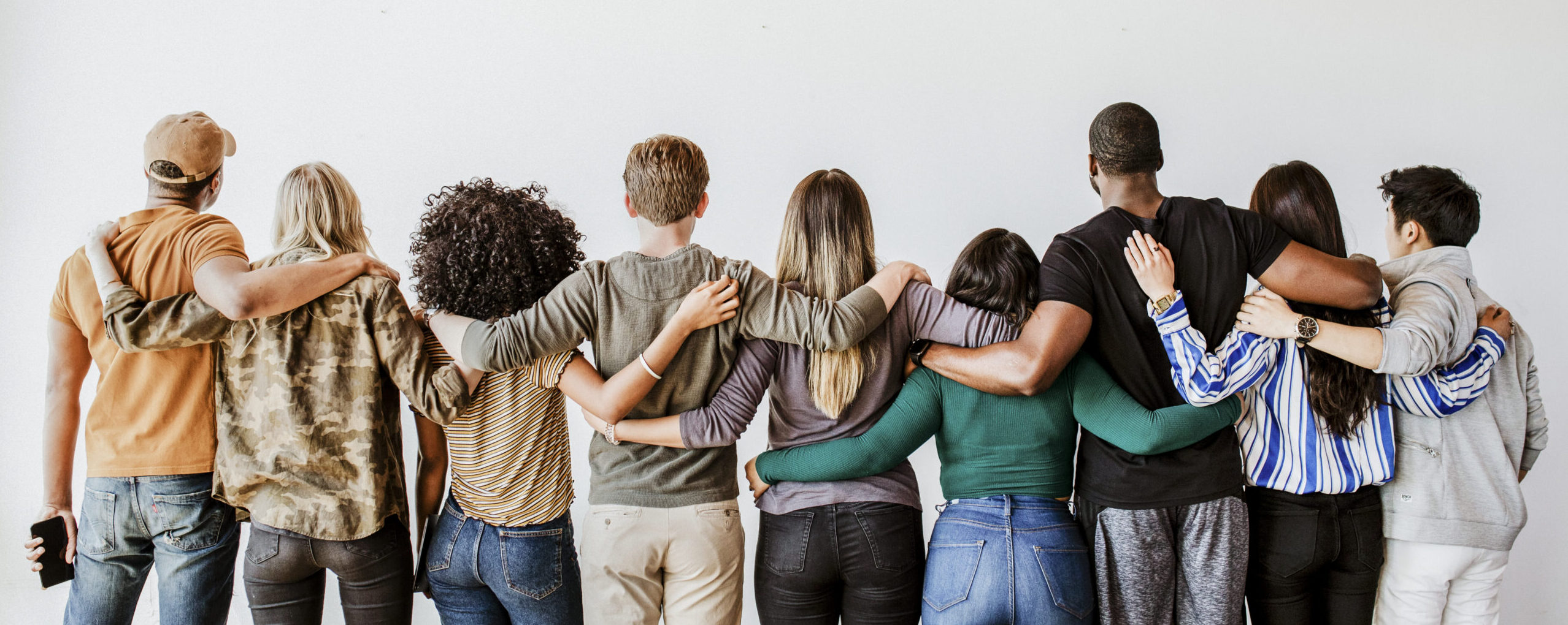 Rearview of diverse people hugging each other